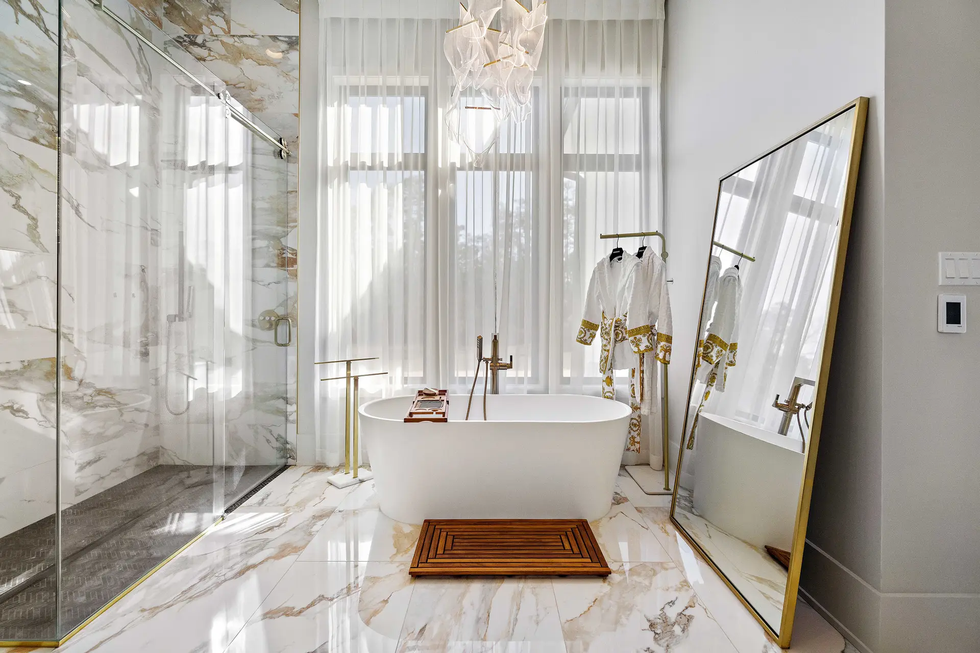 Luxury primary bathroom with custom tile and fixtures in a Troyer Builders modern home