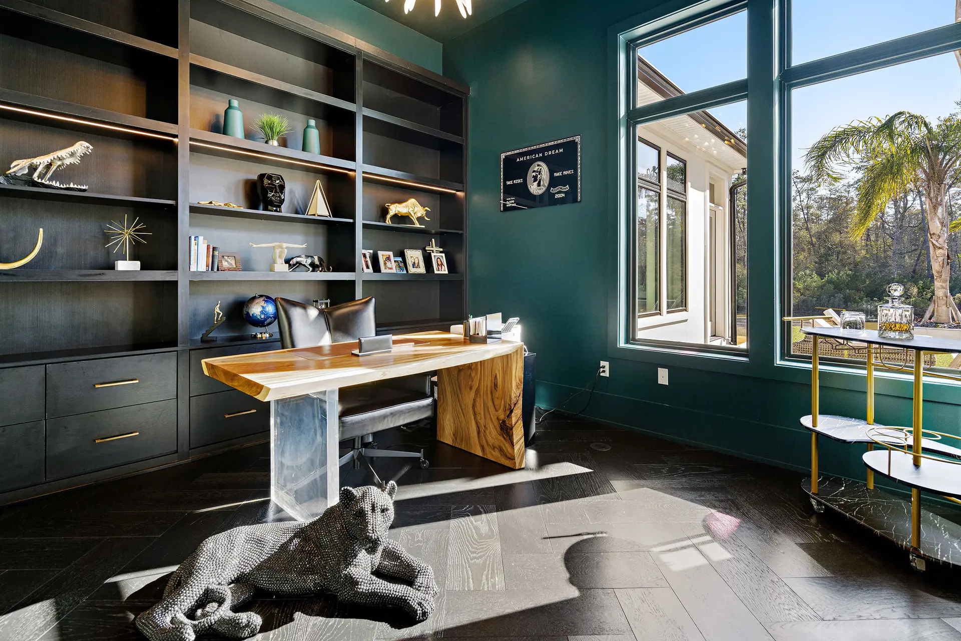 Custom study with built-in shelving and floor-to-ceiling windows designed by Troyer Builders