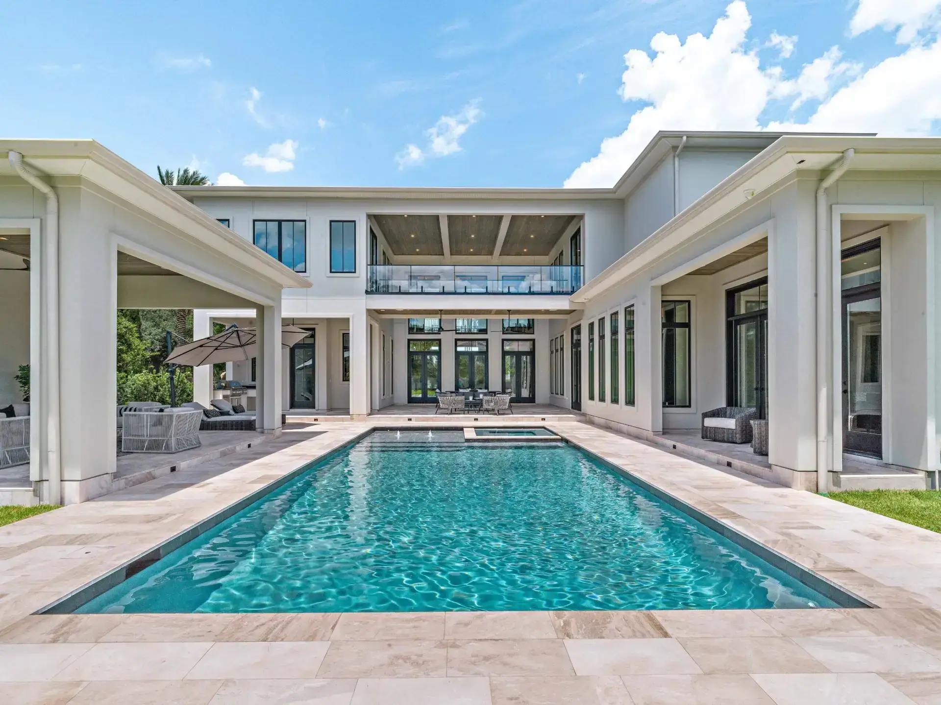 Luxury courtyard pool and covered outdoor living area built for Gulf South weather by Troyer Builders